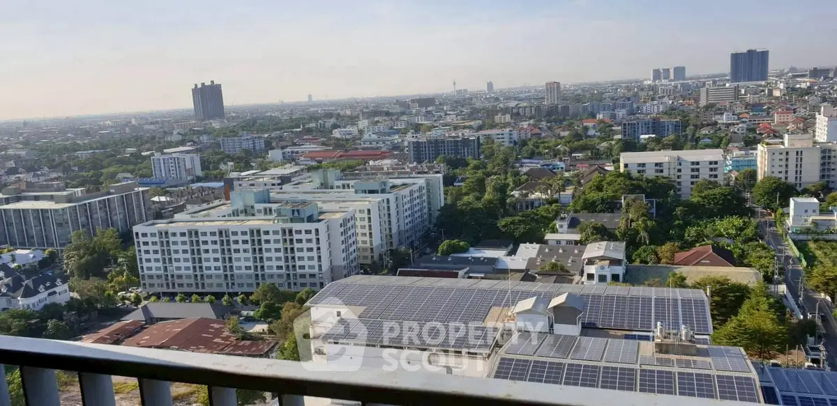 Stunning cityscape view from high-rise balcony showcasing urban skyline and solar panels.