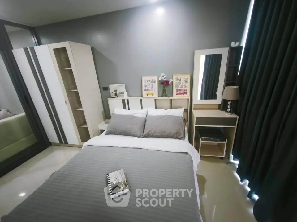 Modern bedroom with stylish decor and ample storage in a cozy apartment.