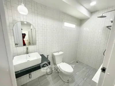 Modern bathroom with sleek white tiles and contemporary fixtures