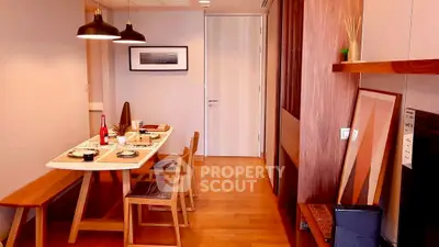 Modern dining area with wooden furniture and stylish decor in a cozy apartment.