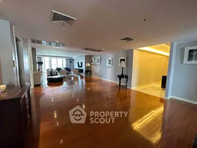 Spacious and elegant living room with polished wooden floors and modern decor.