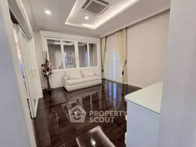 Elegant living room with polished wooden floors and modern decor