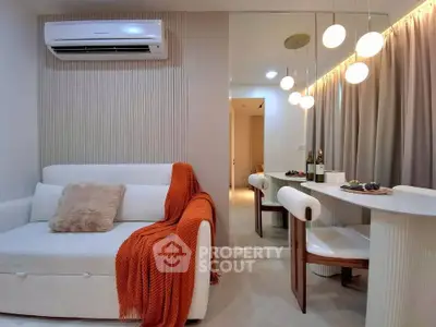 Stylish modern living room with cozy sofa and elegant dining area, perfect for urban living.