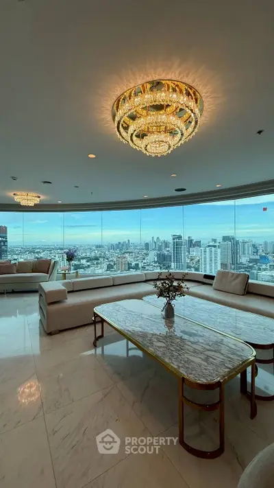 Luxurious living room with panoramic city view and elegant chandeliers.