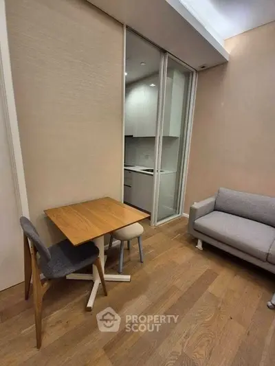Modern compact living space with cozy seating and small dining area