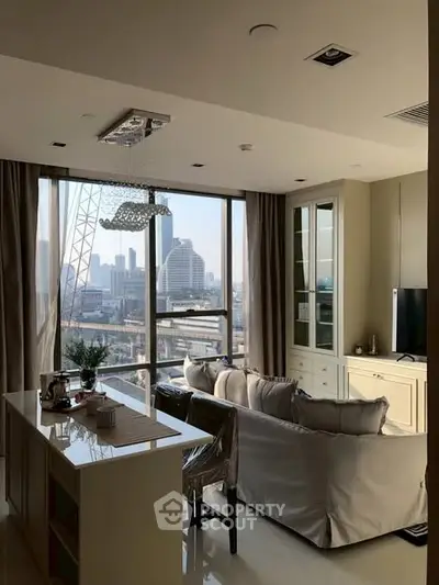 Modern living room with city view, elegant furnishings, and natural light.