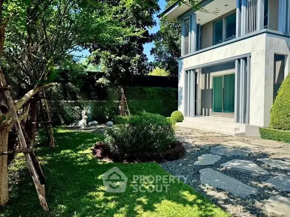 Luxurious modern home with lush garden and elegant facade