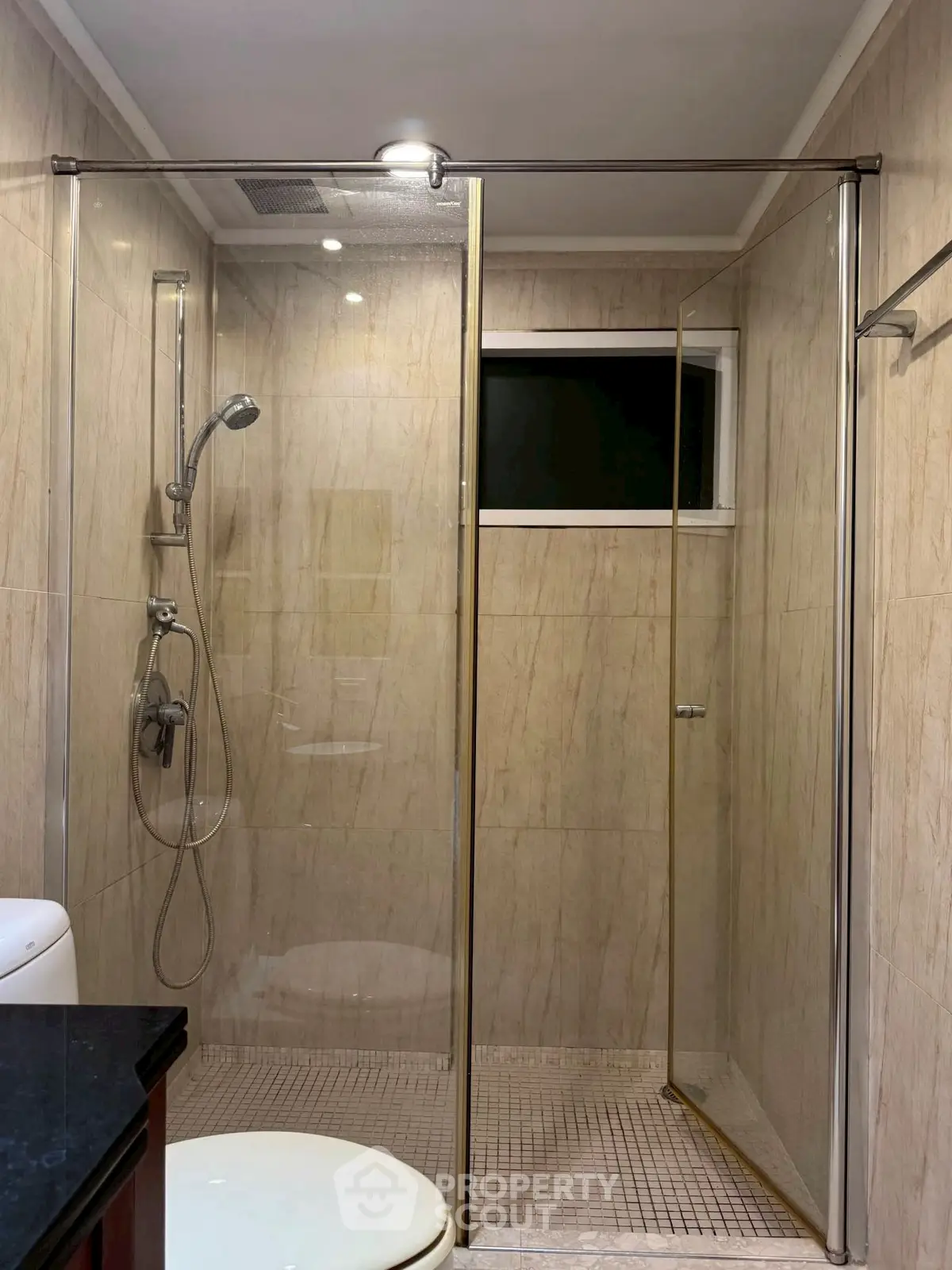 Modern bathroom with glass shower enclosure and sleek fixtures