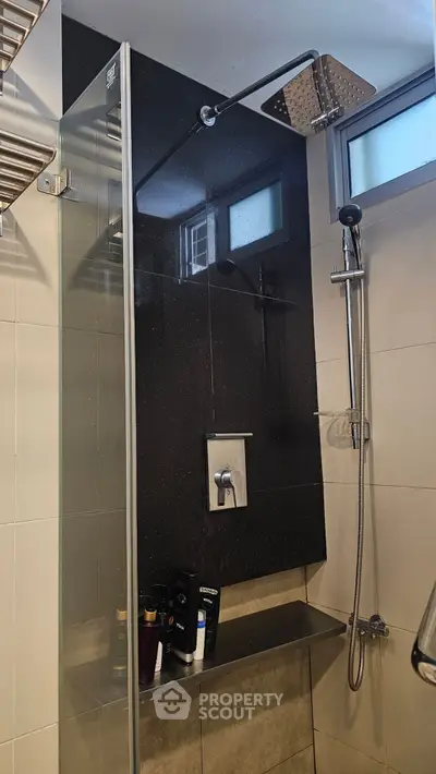 Modern bathroom shower with sleek glass enclosure and rainfall showerhead.