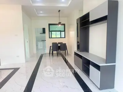 Modern open-plan living and dining area with sleek marble flooring and stylish furniture.