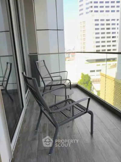 Modern balcony with stylish chairs and city view, perfect for relaxation and urban living.