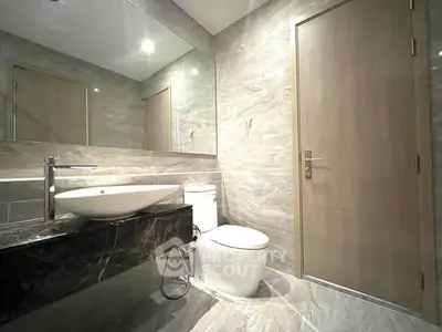 Luxurious modern bathroom with sleek fixtures and elegant marble design.