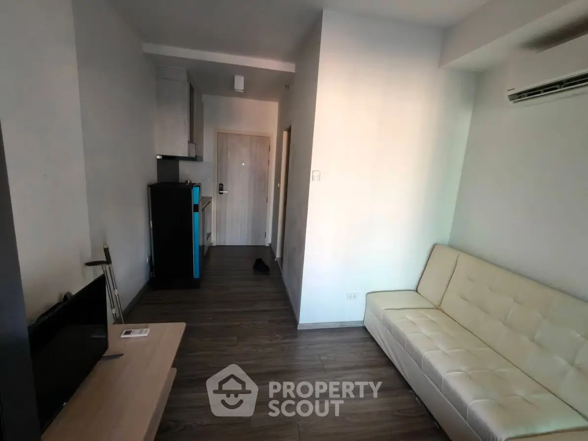 Modern living room with sleek furniture and air conditioning in a cozy apartment.