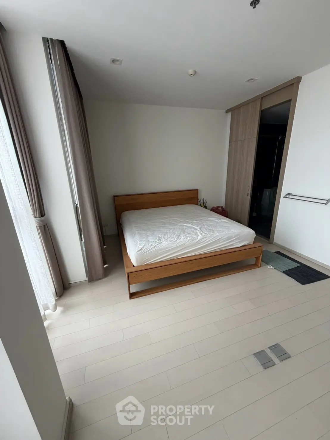 Spacious bedroom with modern design and large windows for natural light