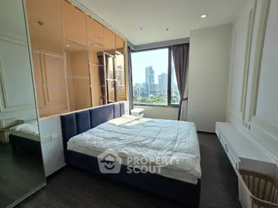 Spacious bedroom with city view and modern decor in high-rise apartment