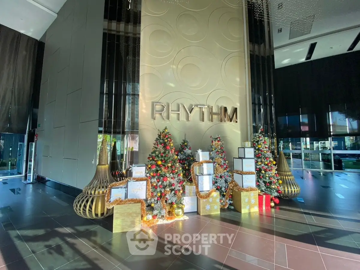 Luxurious building entrance with festive Christmas decorations and elegant design.