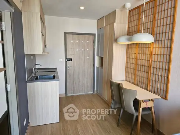 Modern apartment interior with compact kitchen and dining area