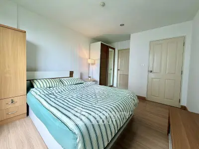 Spacious bedroom with modern decor and ample natural light