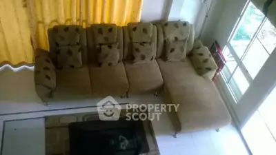Spacious living room with cozy sectional sofa and large window for natural light.