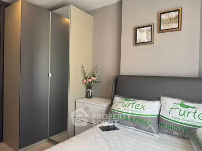 Modern bedroom with stylish decor and cozy ambiance, featuring a sleek wardrobe and elegant wall art.