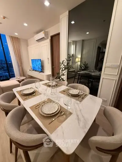 Elegant dining area with marble table and cozy seating in modern apartment