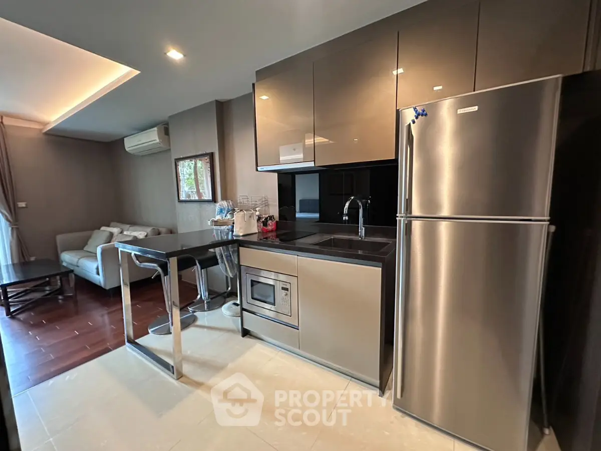 Modern kitchen with sleek appliances and open layout in stylish apartment