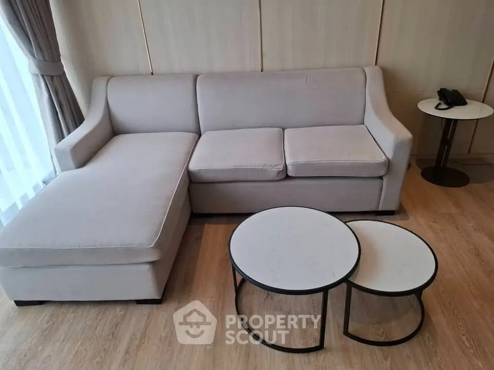 Modern living room with stylish sofa and nested coffee tables