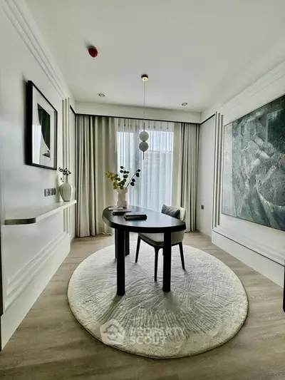 Elegant study room with modern decor and large window, featuring a stylish desk and contemporary artwork.