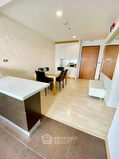 Modern open-plan living and dining area with stylish decor and ample natural light.