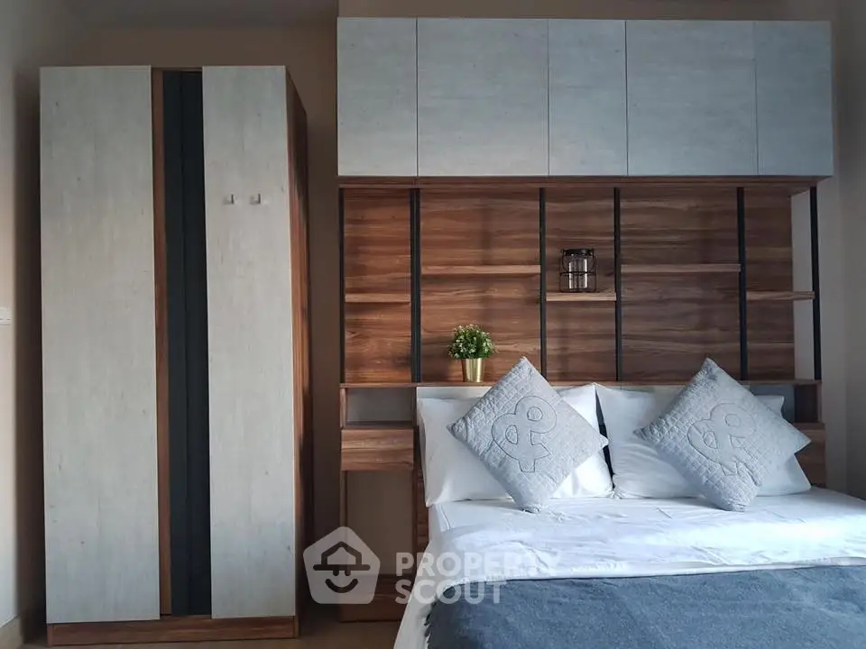 Modern bedroom with stylish wood paneling and cozy bedding