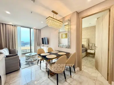 Luxurious open-plan living and dining area with elegant decor and city view.