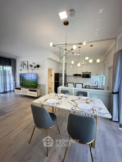 Luxurious open-plan living and dining area with modern kitchen and elegant decor.