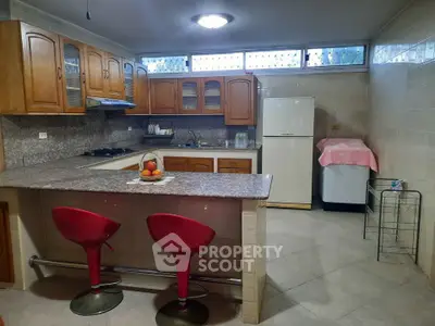Spacious kitchen with wooden cabinets and modern appliances