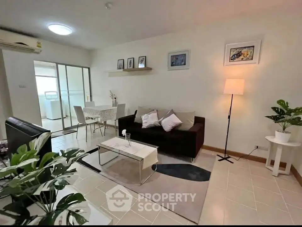 Chic living room with modern decor and open dining area, perfect for cozy gatherings.