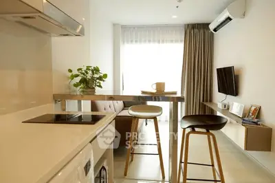 Modern open-plan living room with sleek kitchen and stylish decor