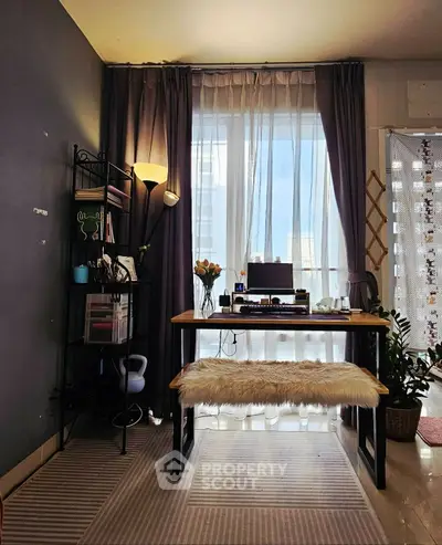 Chic study area with natural light, modern desk, and cozy decor.