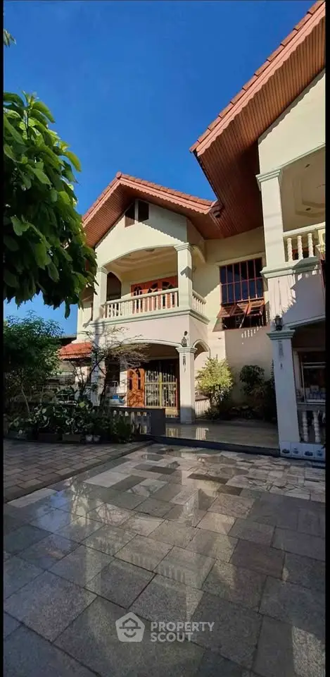 Charming two-story house with spacious front yard and elegant balcony, perfect for family living.