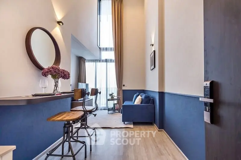 Modern living room with high ceiling and stylish decor