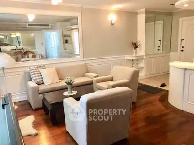 Charming living room with elegant decor and cozy seating in a stylish apartment.
