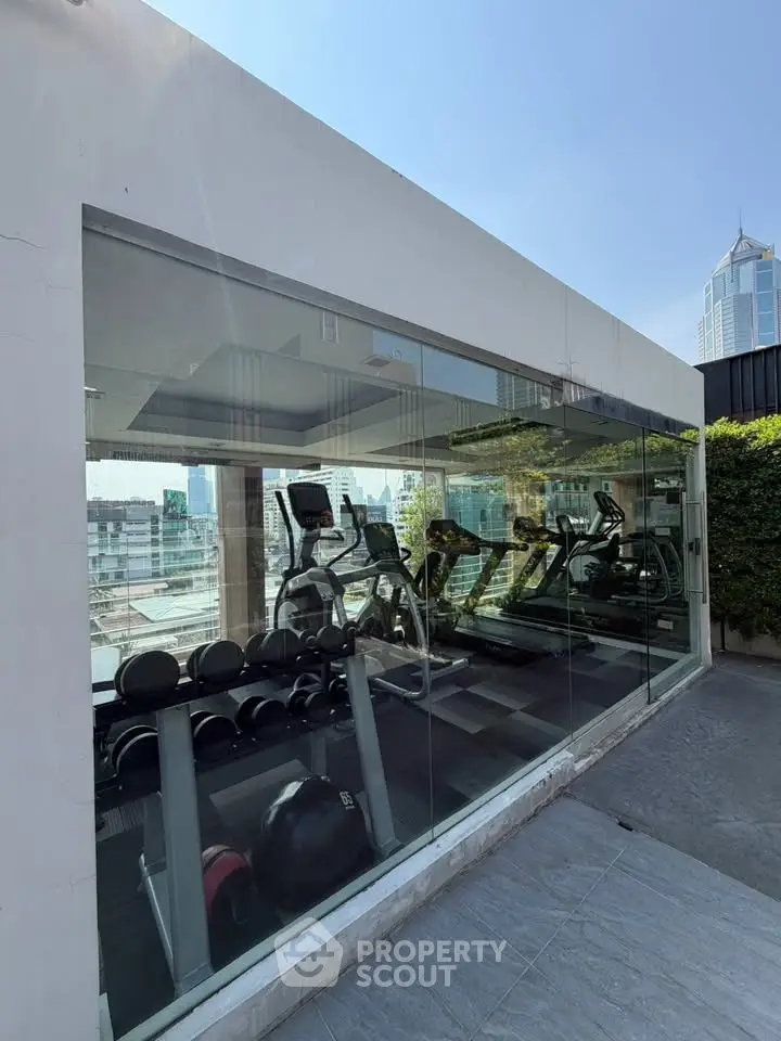 Modern gym with city view in luxury residential building