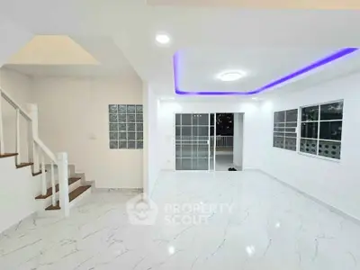 Modern living room with marble flooring and LED ceiling lights