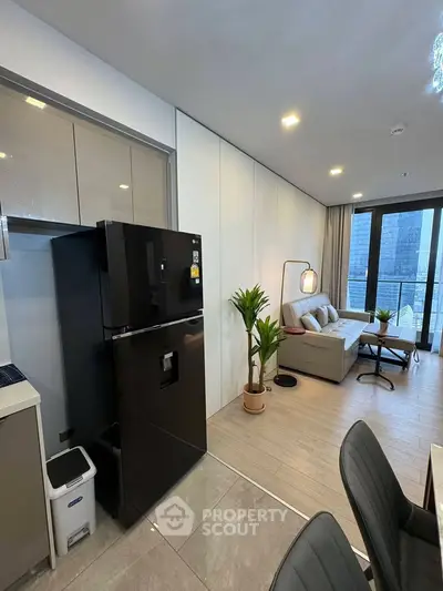Modern open-layout living room with sleek kitchen and large windows offering city views.