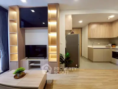 Modern living room with open kitchen, sleek wooden shelves, and stylish decor