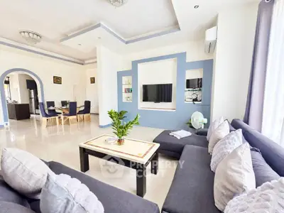 Spacious modern living room with elegant decor and open dining area