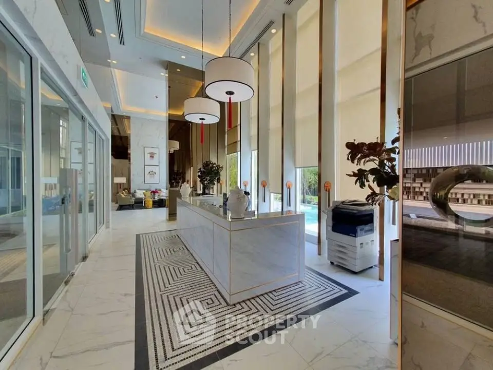 Luxurious modern lobby with high ceilings and elegant decor in a prestigious building.