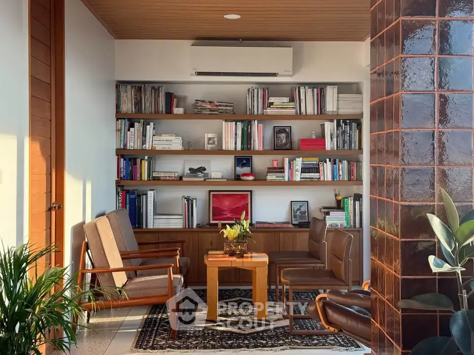 Chic living room with stylish furniture and built-in bookshelf, perfect for modern urban living.