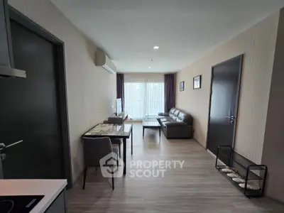 Modern living room with sleek furniture and natural light, perfect for relaxation and entertainment.