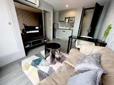 Modern living room with stylish decor and compact kitchen area