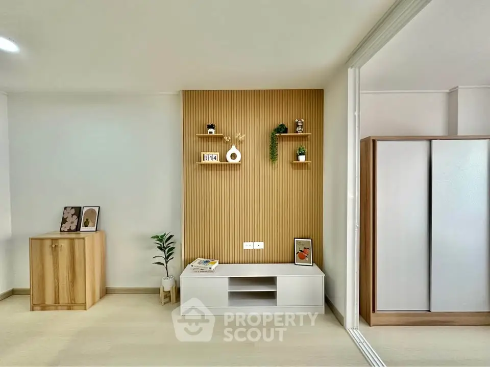 Modern living room with stylish wooden paneling and minimalist decor