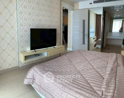 Modern bedroom with stylish decor and mounted TV in a luxurious apartment.